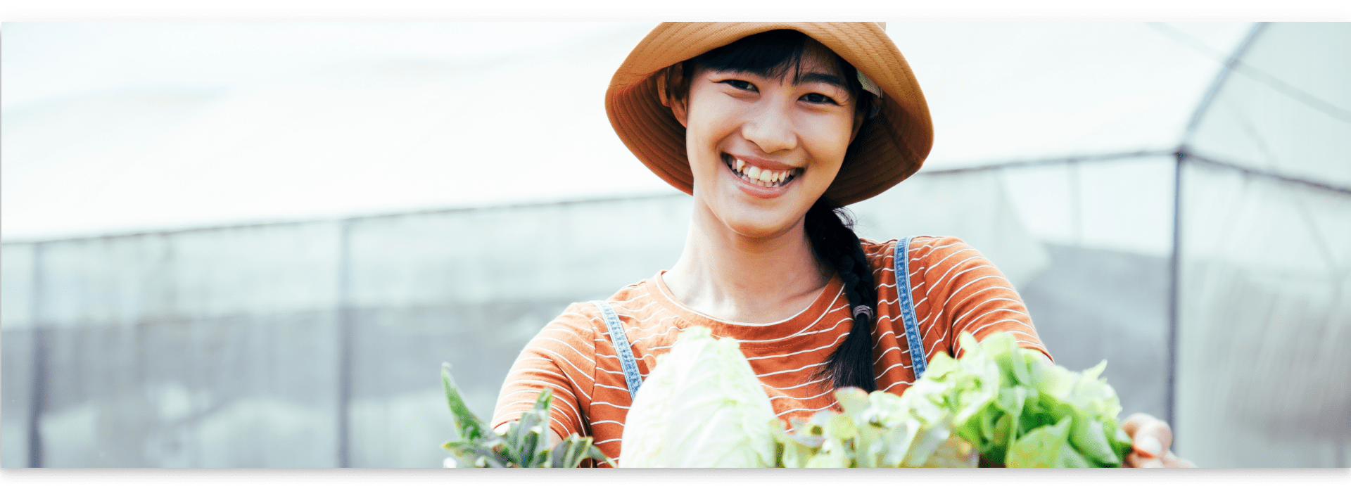 girl smiling and got plants in her hands